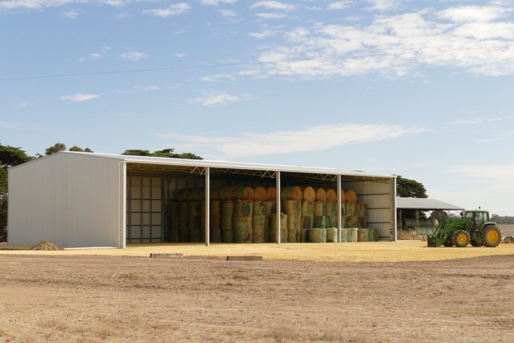 Hay shed with round bales stacked