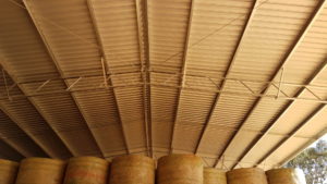 Hay stacked and stored in an open web truss shed