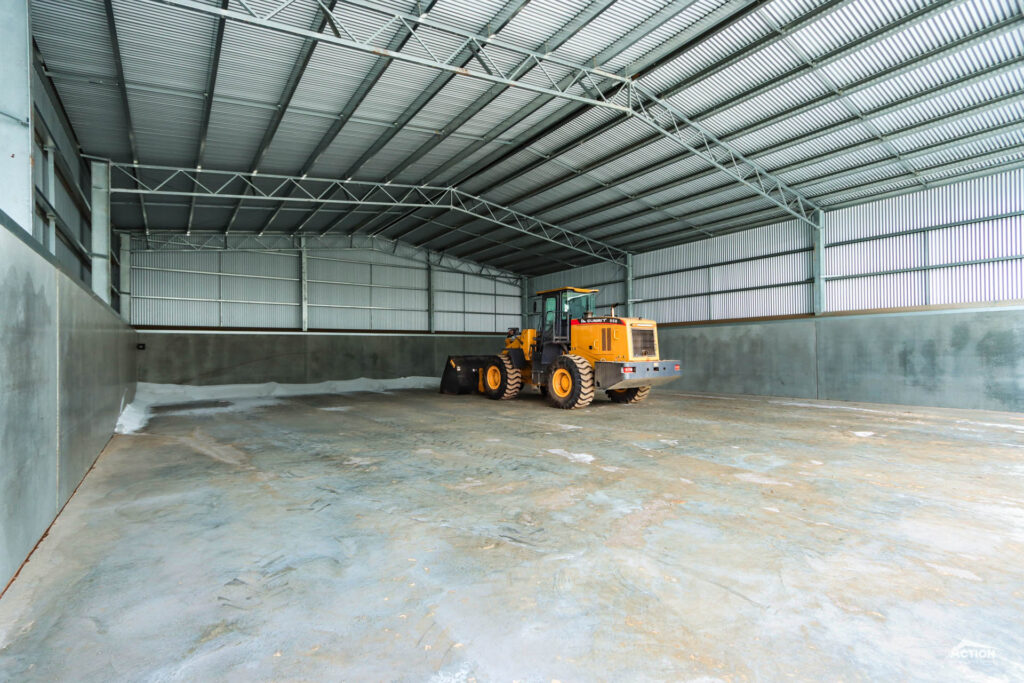 Concrete panel fert shed with loader