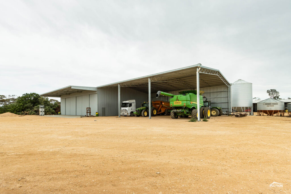 Machinery shed with enclosed bays and canopy and open gable