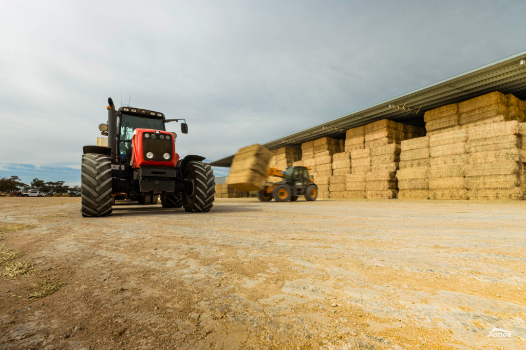 telehandler loading hay shed