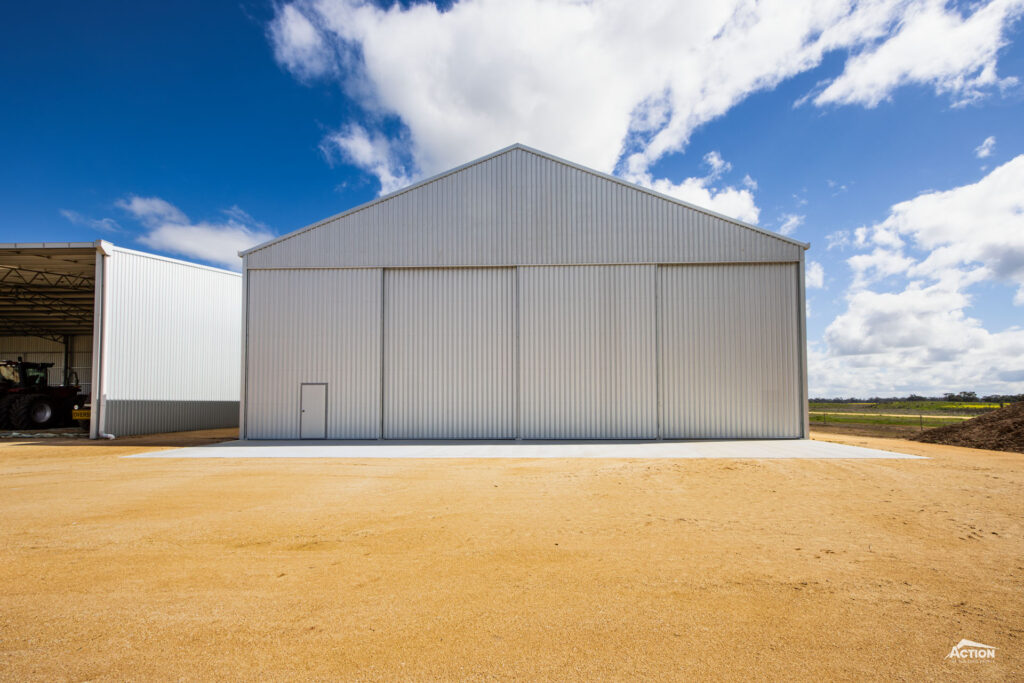Steep roof pitch grain shed with personal access door