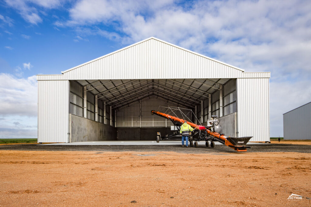 grain or fertiliser shed with steep roof pitch and outriggers
