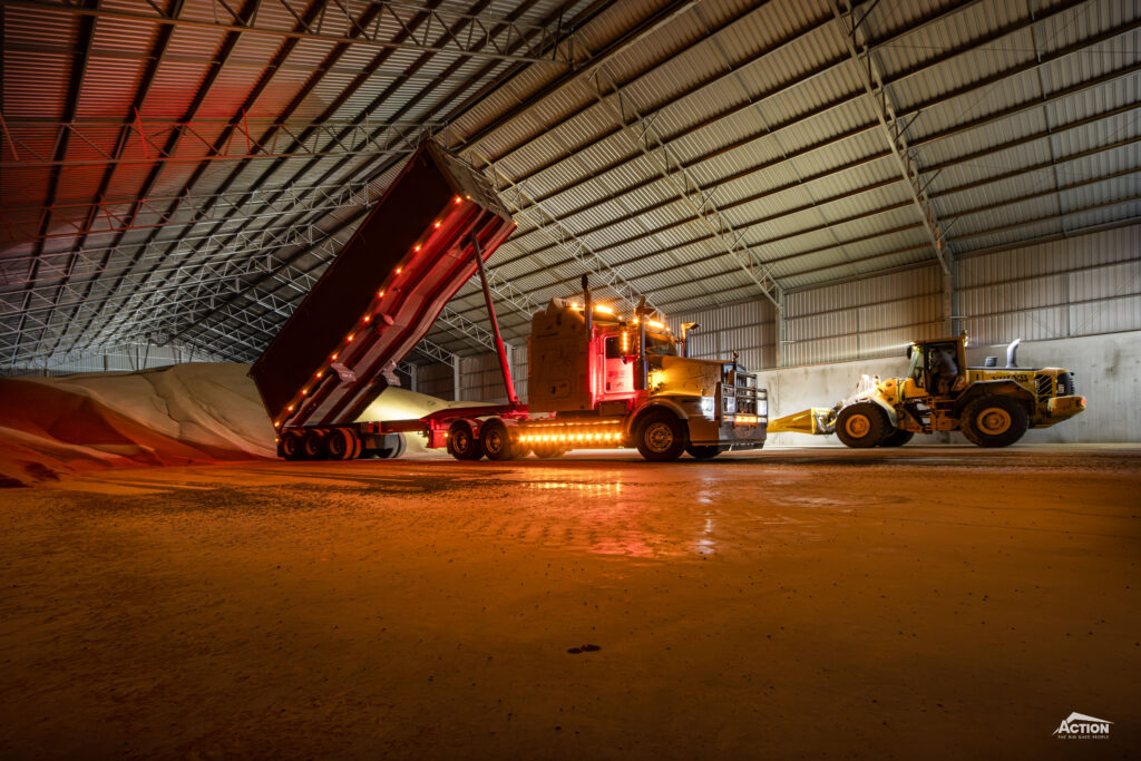 truck tipping inside grain shed at harvest time